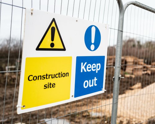 Construction site signs including PPE hazard and access signage